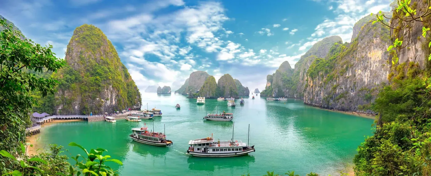 Halong Bay limestone karsts with traditional Vietnamese boats